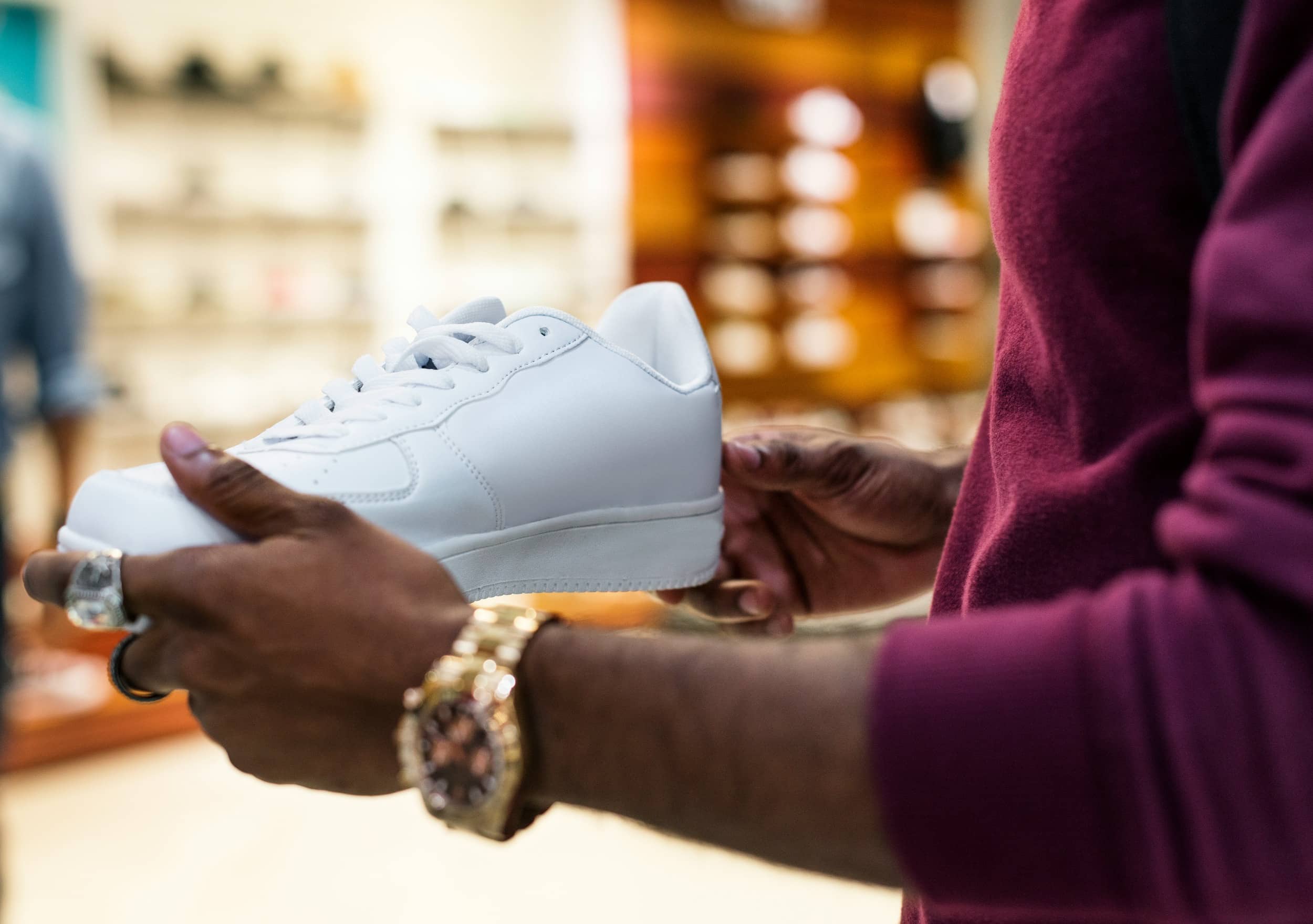 Person holding white sneaker