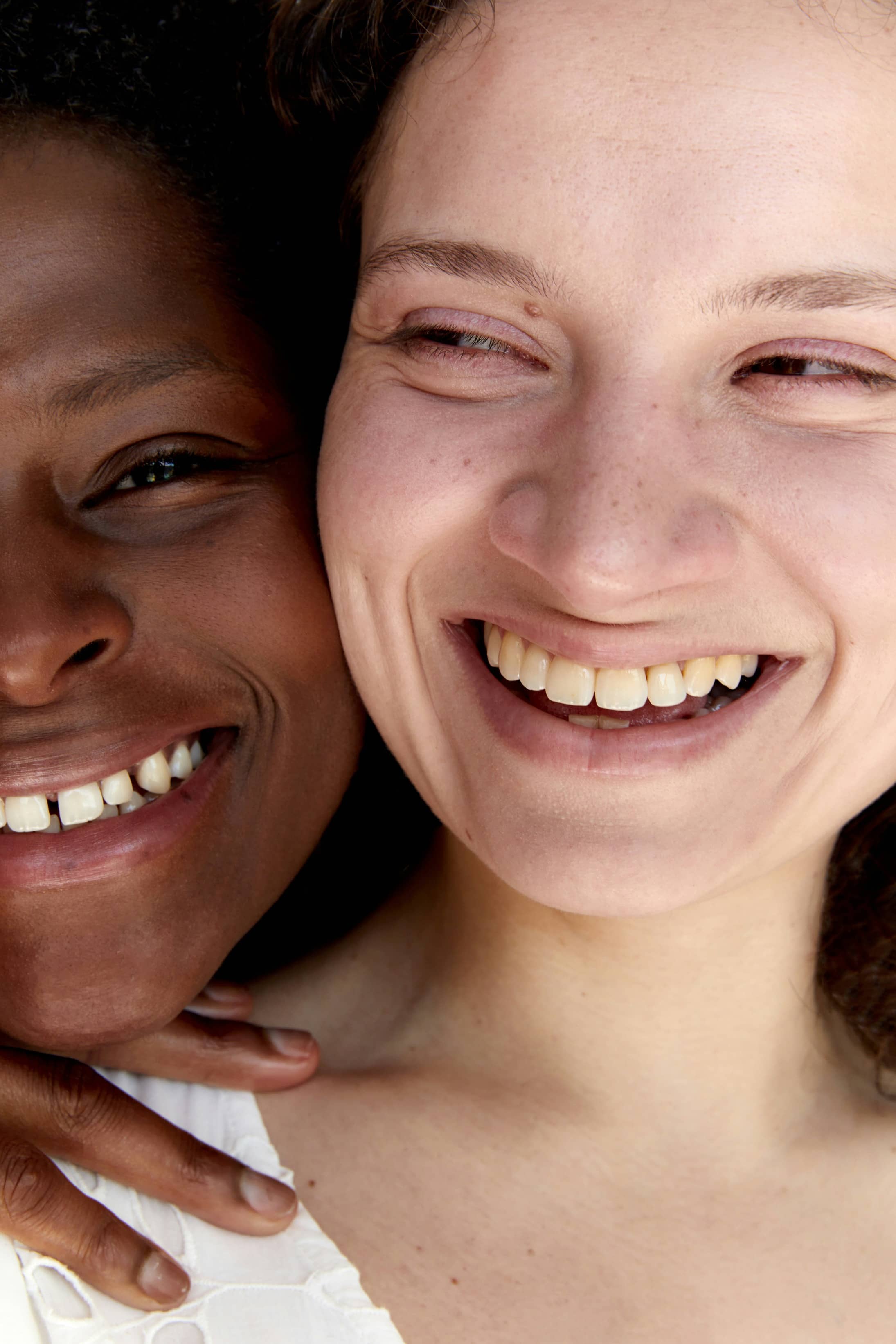 Close-up of two women smiling with faces touching